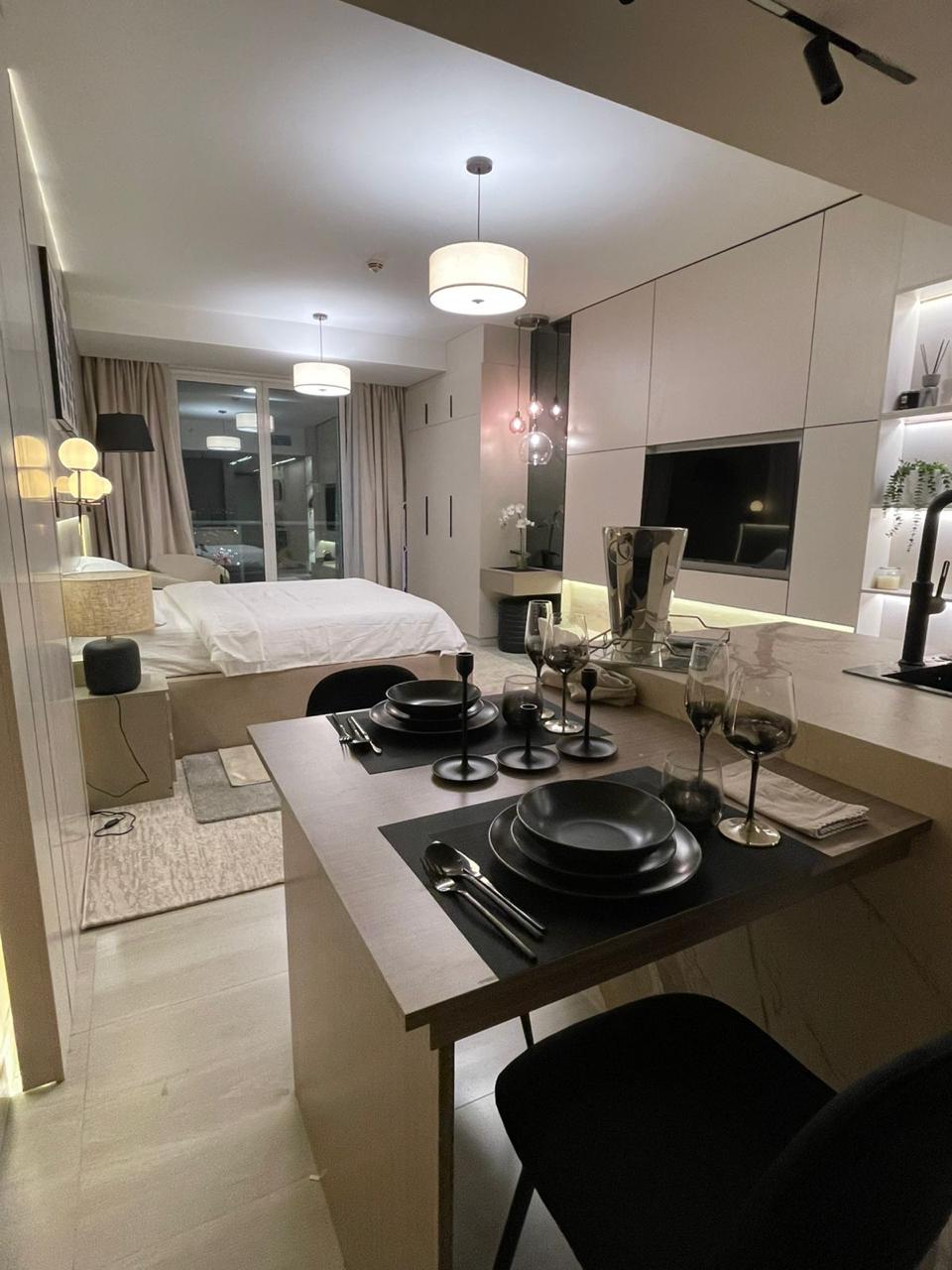 Open-plan living with marble dining island and Dubai Marina view
